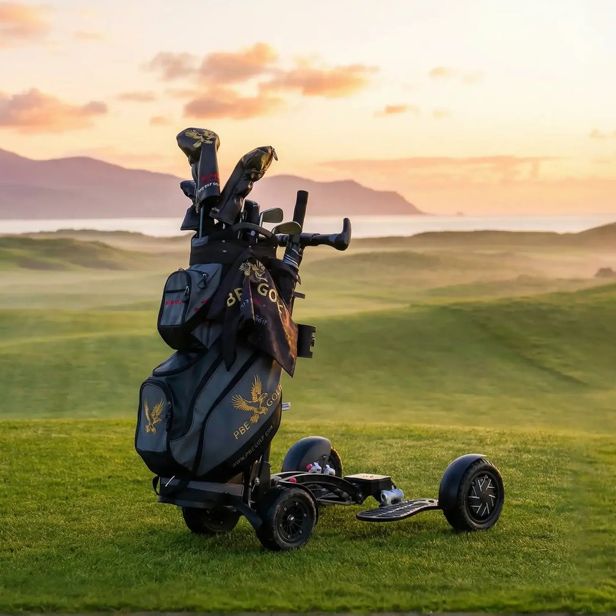 Golf bag with clubs on a trolley in a scenic golf course at sunset