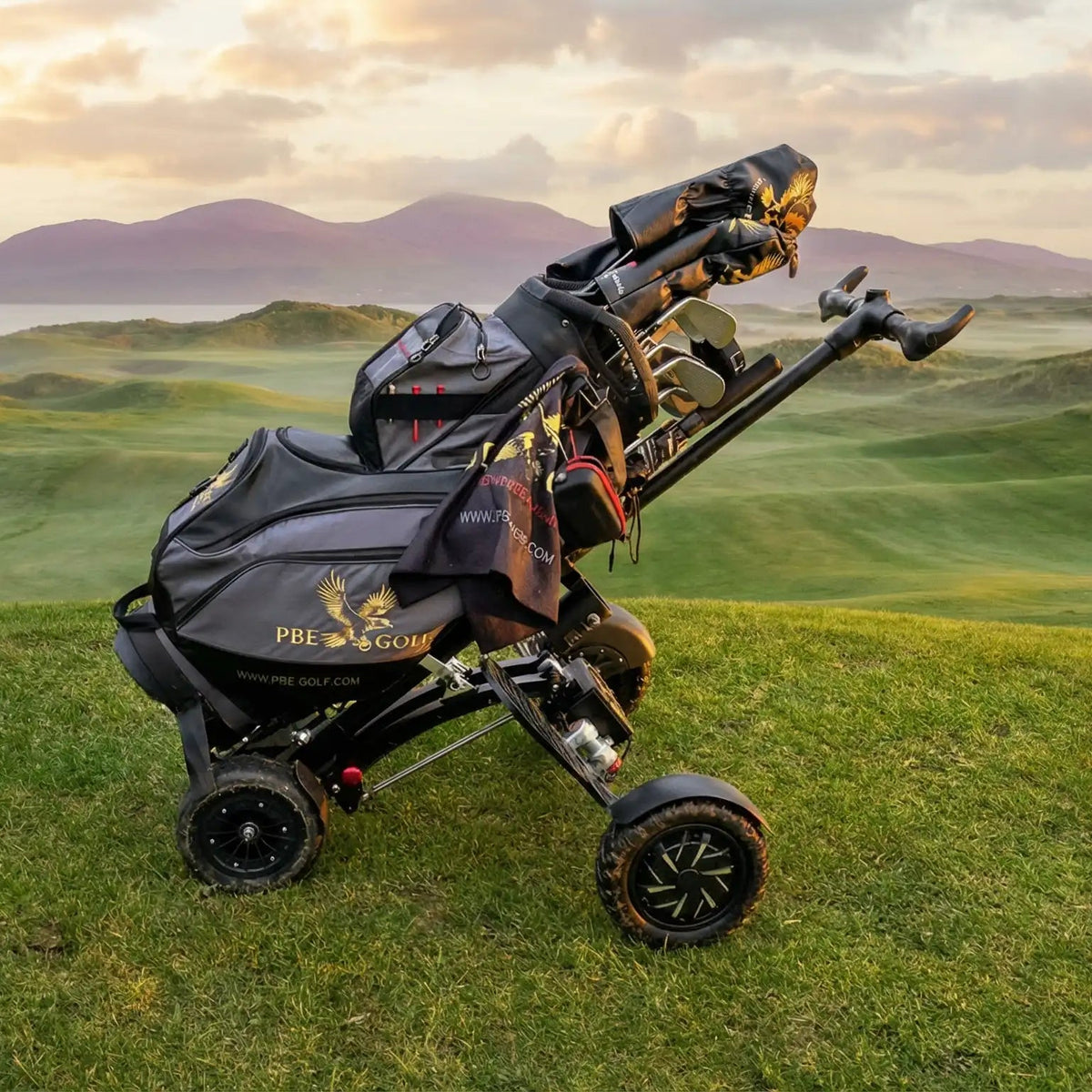 Golf trolley on a golf course with mountains in the background