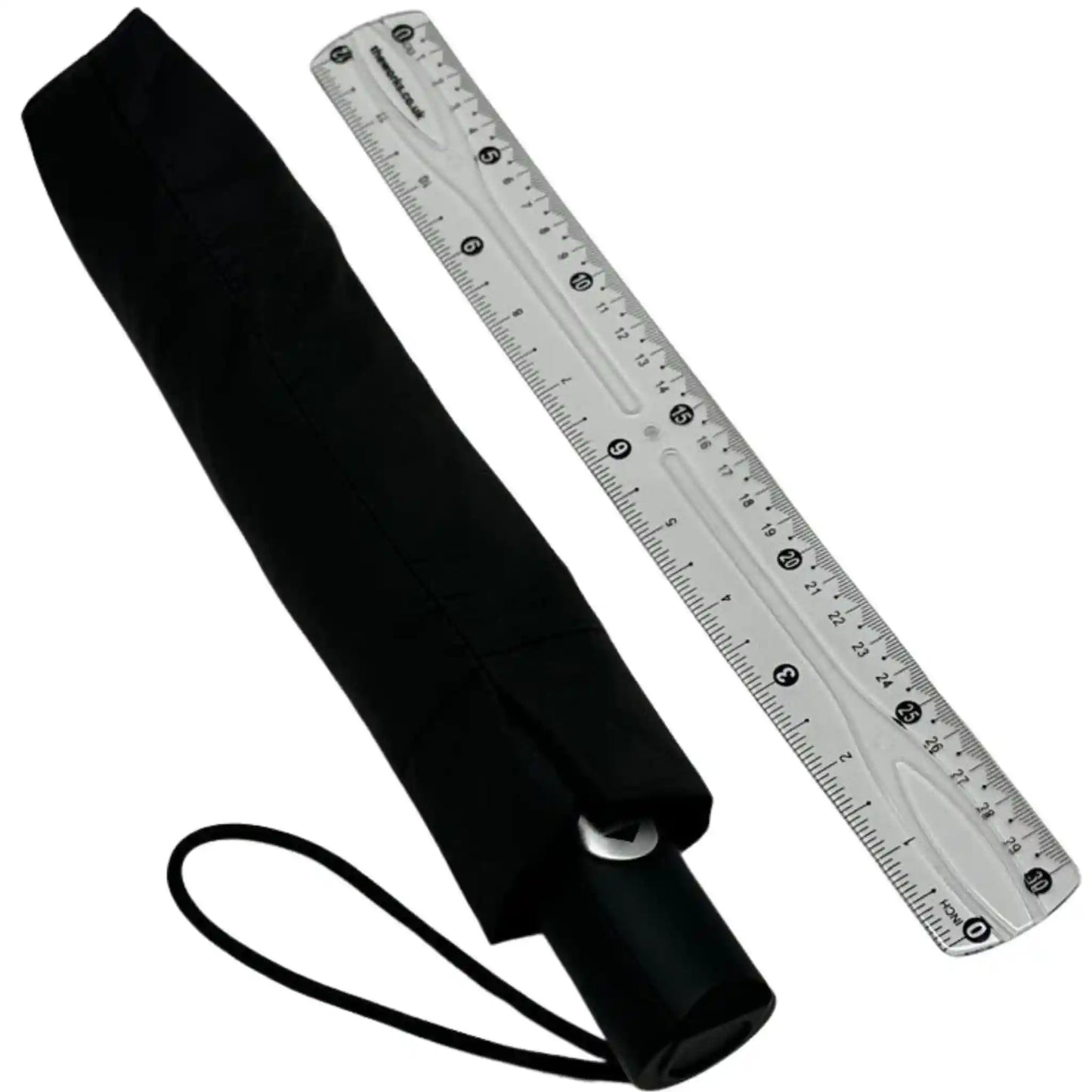 Black umbrella with a clear ruler for scale on a white background