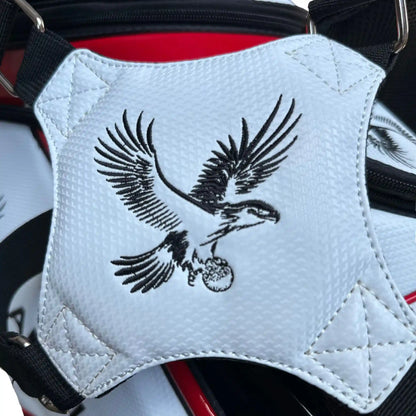 White golf bag strap with an eagle design on a red and black background