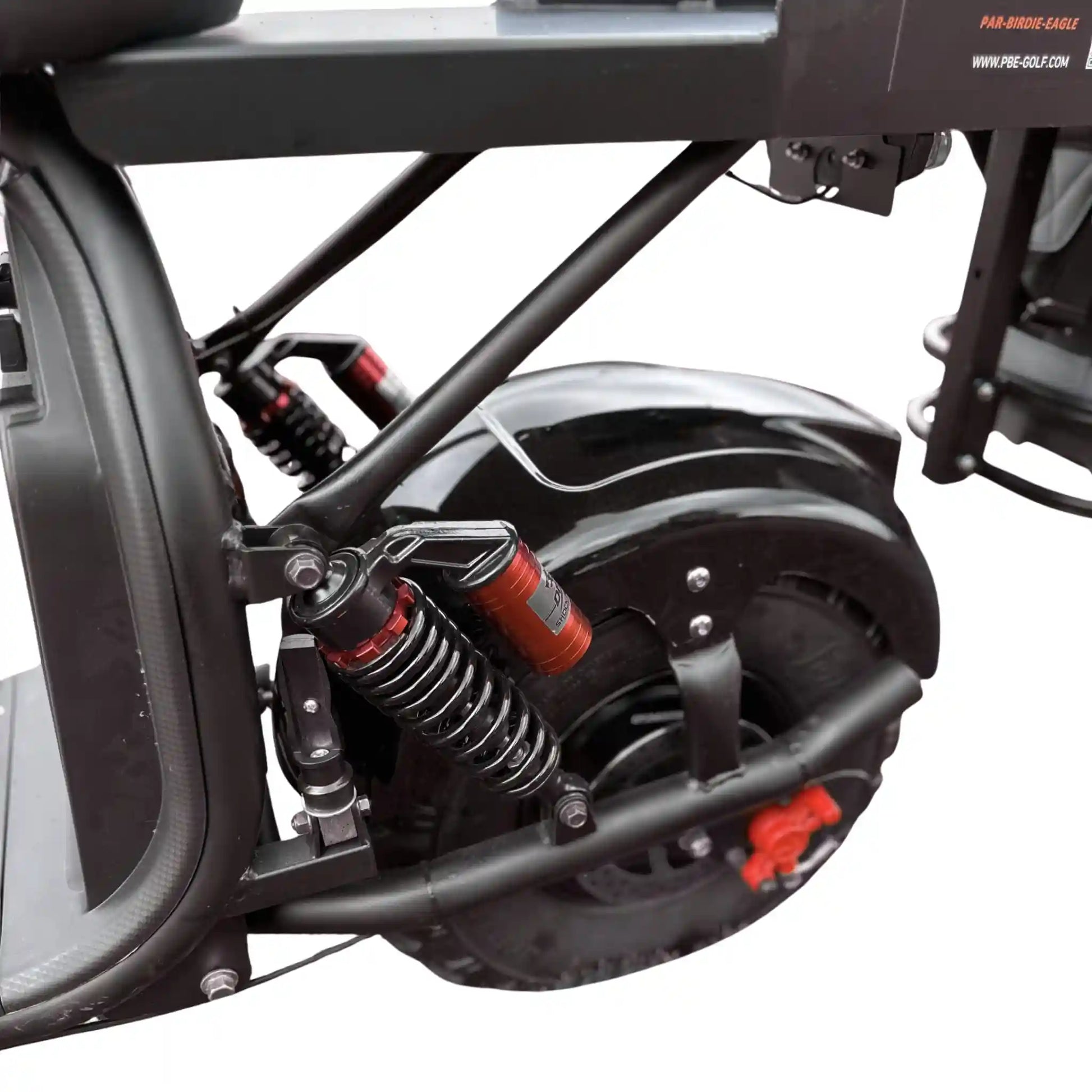 Close-up of a motorcycle suspension system with visible branding on a white background