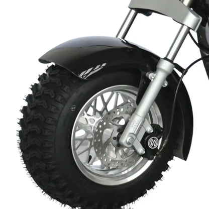 Close-up of a motorcycle wheel with rugged tire on a white background